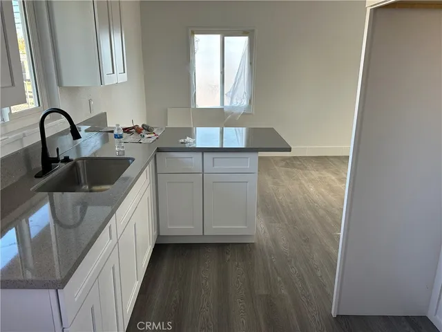a kitchen with a refrigerator and a stove top oven