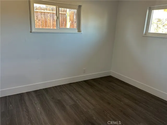a bathroom with a granite countertop toilet sink and mirror