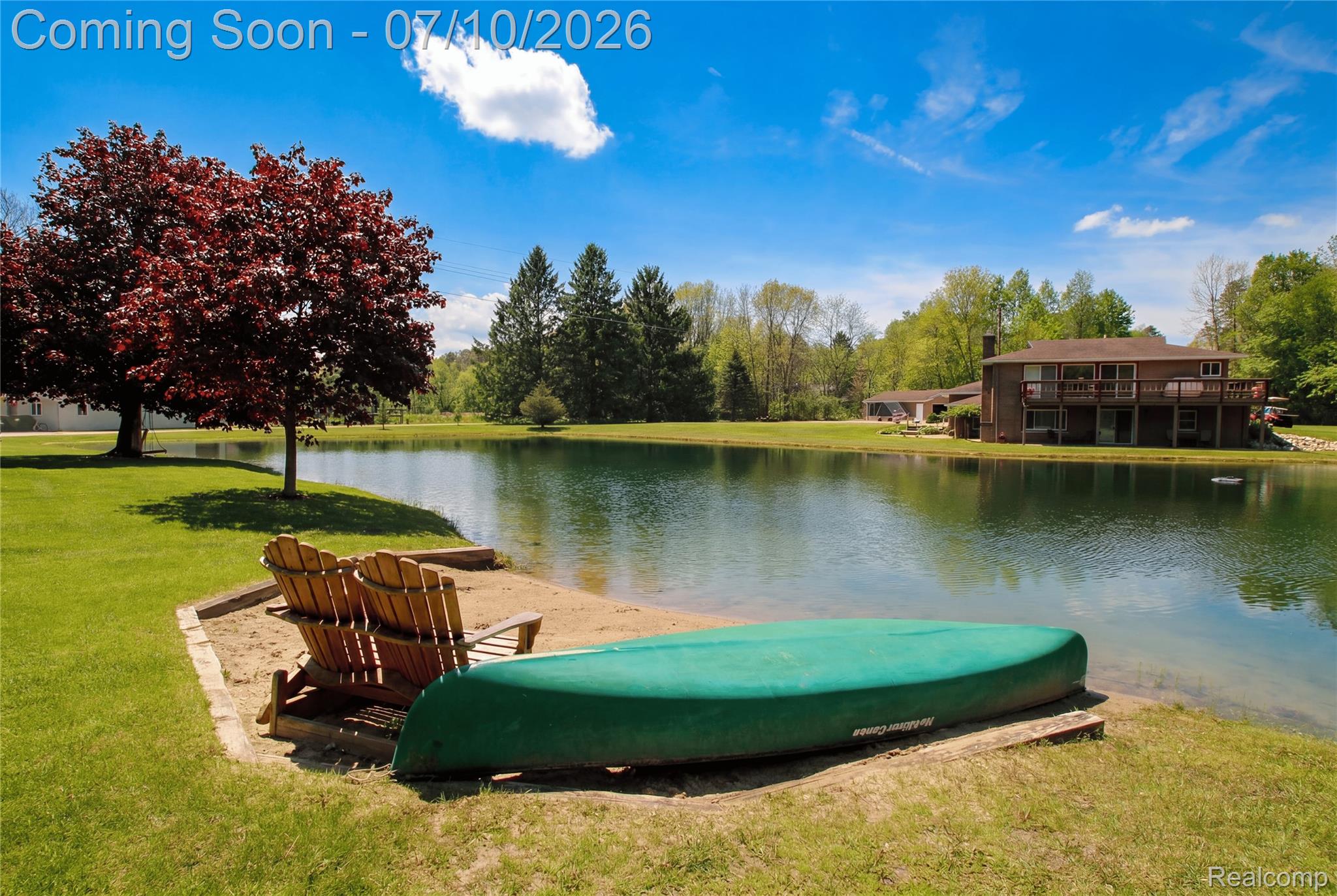 5278 Skelton Road Columbiaville, MI 48421 - Photo 64 of 64 Private pond with a sandy shoreline, expansive grassy areas, and mature trees