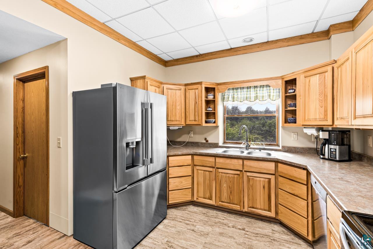4800 Tower Road Moose Lake, MN 55767 - Photo 7 of 83 Well-appointed kitchen featuring light wood cabinetry, a stainless steel refrigerator, and ample countertop space