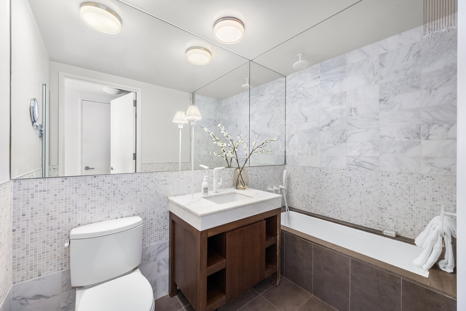 35 West 15th Street, Unit 13C Manhattan, NY 10011 - Photo 12 of 17 a bathroom with a sink a toilet and mirror