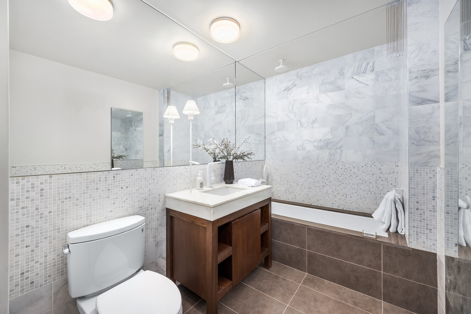 35 West 15th Street, Unit 13C Manhattan, NY 10011 - Photo 14 of 17 a bathroom with a sink a toilet and a mirror
