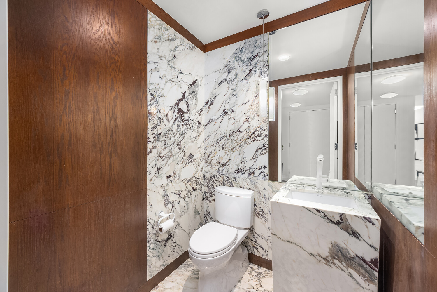35 West 15th Street, Unit 13C Manhattan, NY 10011 - Photo 15 of 17 a white toilet sitting next to a bathroom sink