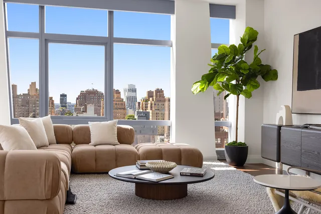 a living room with furniture kitchen and a table