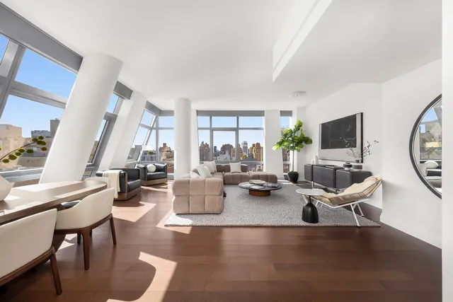 a living room with furniture and a potted plant