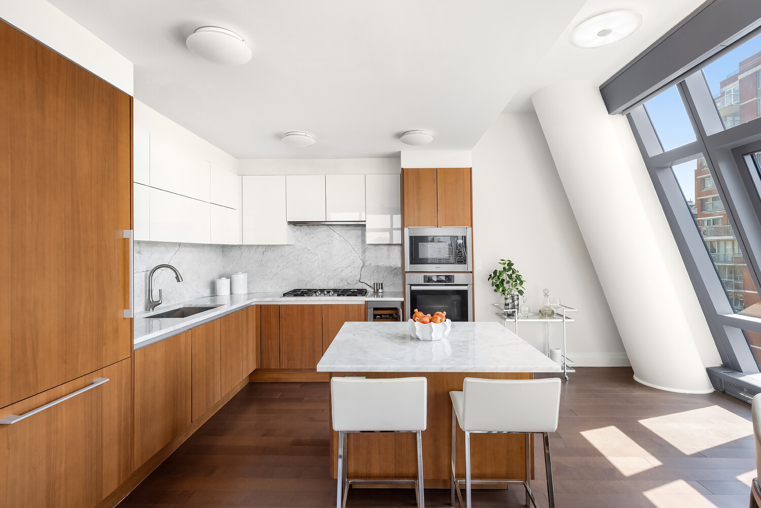 35 West 15th Street, Unit 13C Manhattan, NY 10011 - Photo 7 of 17 a kitchen with a table chairs sink and cabinets