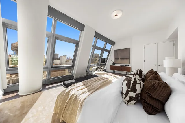 a bedroom with bed couch and window