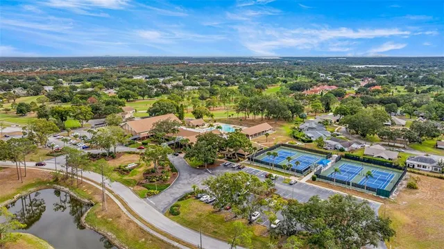 an aerial view of residential houses with outdoor space and trees