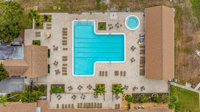 aerial view of a house with a yard and a fire pit
