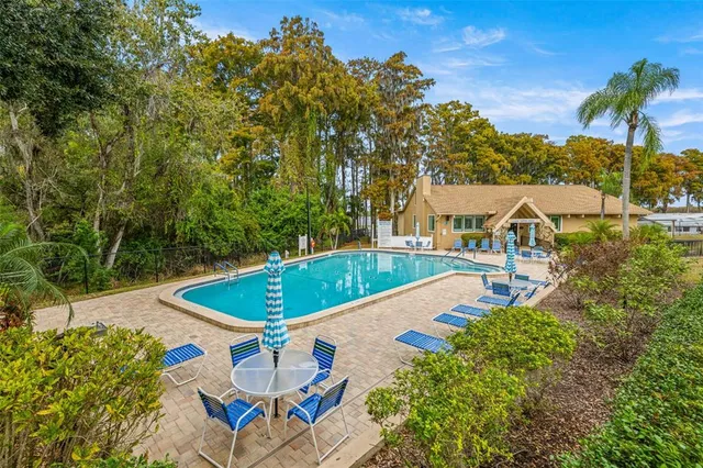 a view of an house with backyard and sitting area