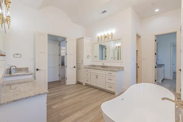 a bathroom with a sink a vanity and a mirror