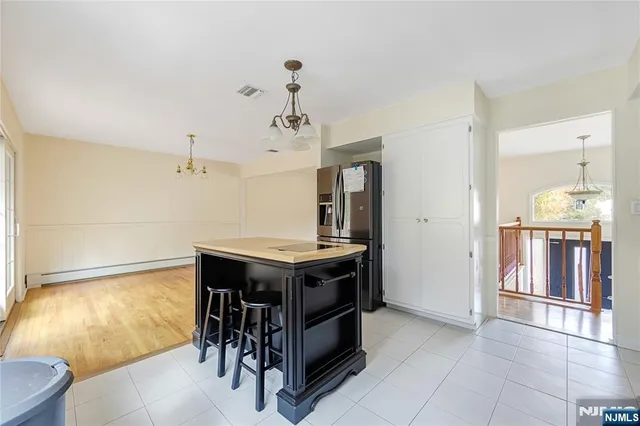 a kitchen with stainless steel appliances granite countertop a stove and a refrigerator
