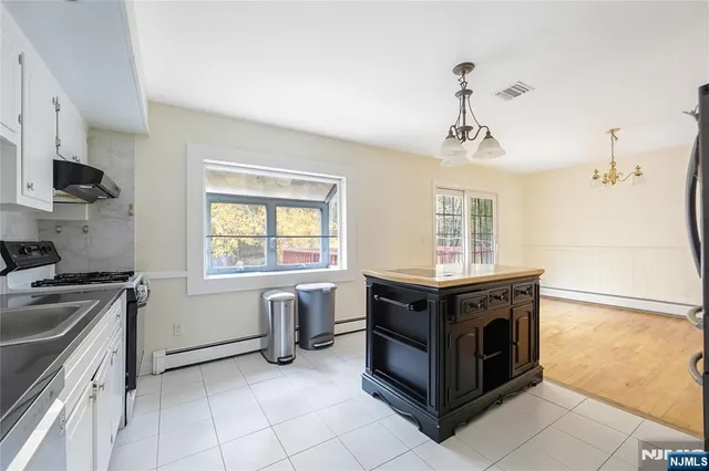 a kitchen with stainless steel appliances granite countertop a stove and a sink