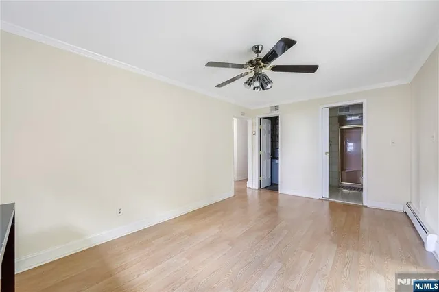 a view of a big room with wooden floor and windows in a room