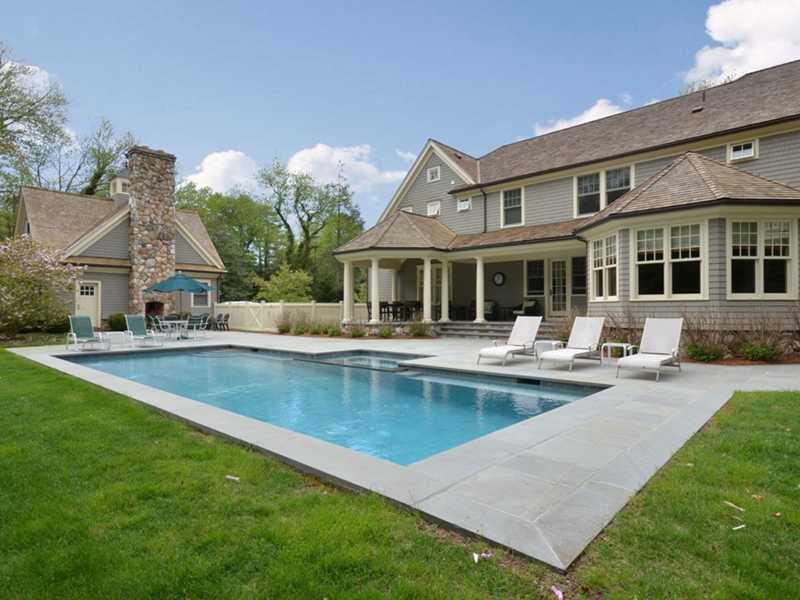 253 Middlesex Road Darien, CT 06820 - Photo 2 of 25 a front view of a house with swimming pool and outdoor seating