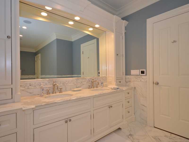 253 Middlesex Road Darien, CT 06820 - Photo 13 of 25 a bathroom with double sink and a mirror