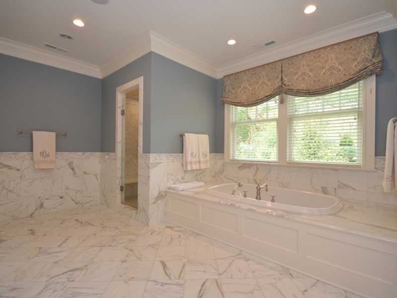 253 Middlesex Road Darien, CT 06820 - Photo 14 of 25 a bathroom with a double vanity sink and a bathtub