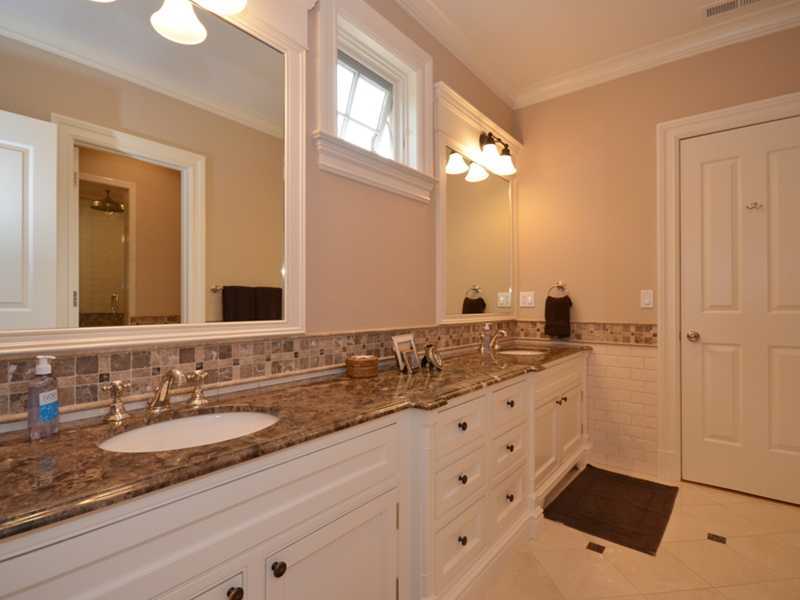 253 Middlesex Road Darien, CT 06820 - Photo 17 of 25 a bathroom with double sink and a mirror