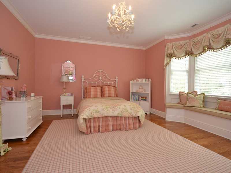 253 Middlesex Road Darien, CT 06820 - Photo 19 of 25 a bedroom with a large bed and a chandelier