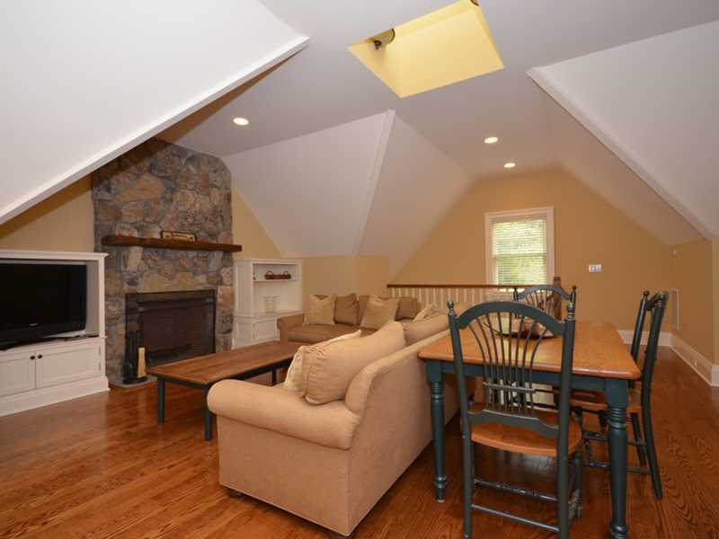 253 Middlesex Road Darien, CT 06820 - Photo 23 of 25 a living room with furniture a fireplace and a flat screen tv