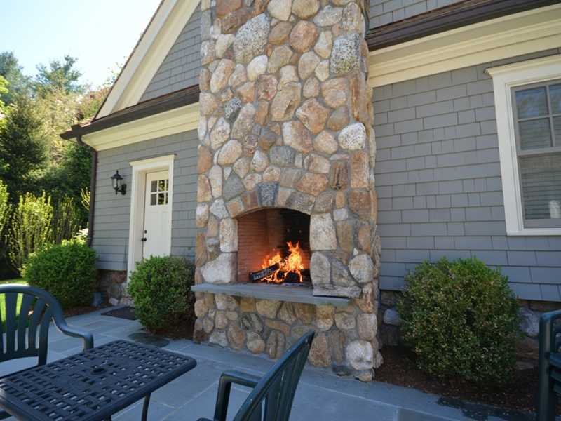 253 Middlesex Road Darien, CT 06820 - Photo 25 of 25 a front view of a house with outdoor seating and plants
