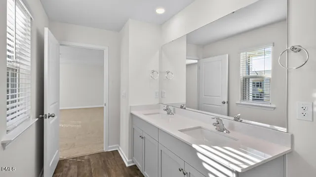 a bathroom with a tub sink and mirror