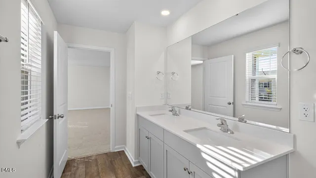 a bathroom with a tub sink and mirror