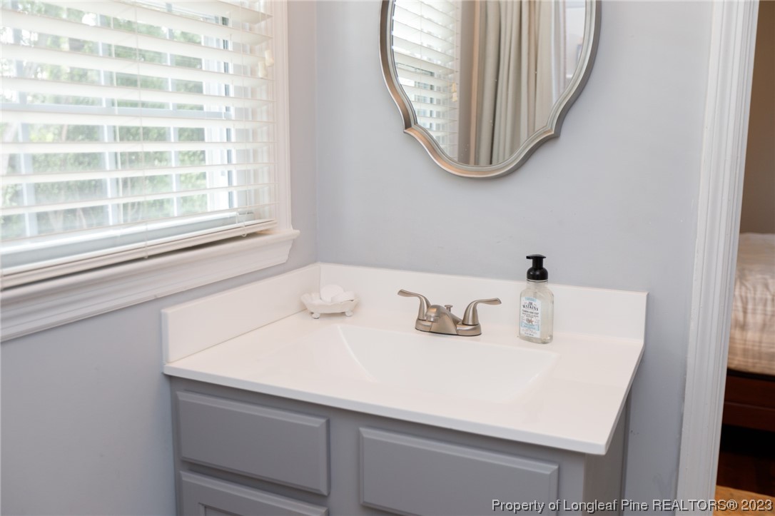2620 Huntington Road Fayetteville, NC 28303 - Photo 16 of 23 a bathroom with a sink and a mirror