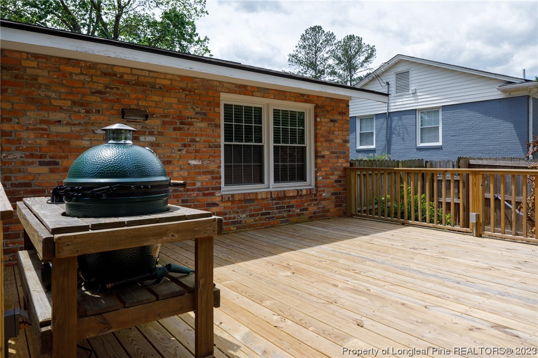 2620 Huntington Road Fayetteville, NC 28303 - Photo 19 of 23 a front view of a house with barbeque grill and wooden floor