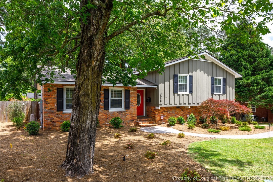 2620 Huntington Road Fayetteville, NC 28303 - Photo 2 of 23 a front view of a house with a yard and large tree