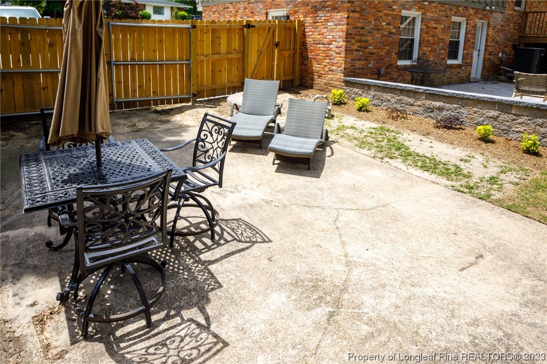 2620 Huntington Road Fayetteville, NC 28303 - Photo 22 of 23 a view of a patio with a table and chairs