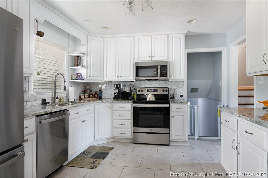 2620 Huntington Road Fayetteville, NC 28303 - Photo 5 of 23 a kitchen with stainless steel appliances a stove sink and microwave