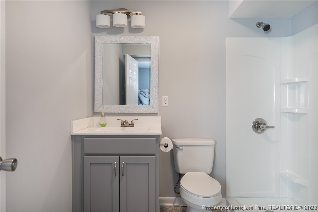 2620 Huntington Road Fayetteville, NC 28303 - Photo 7 of 23 a bathroom with a toilet sink and mirror