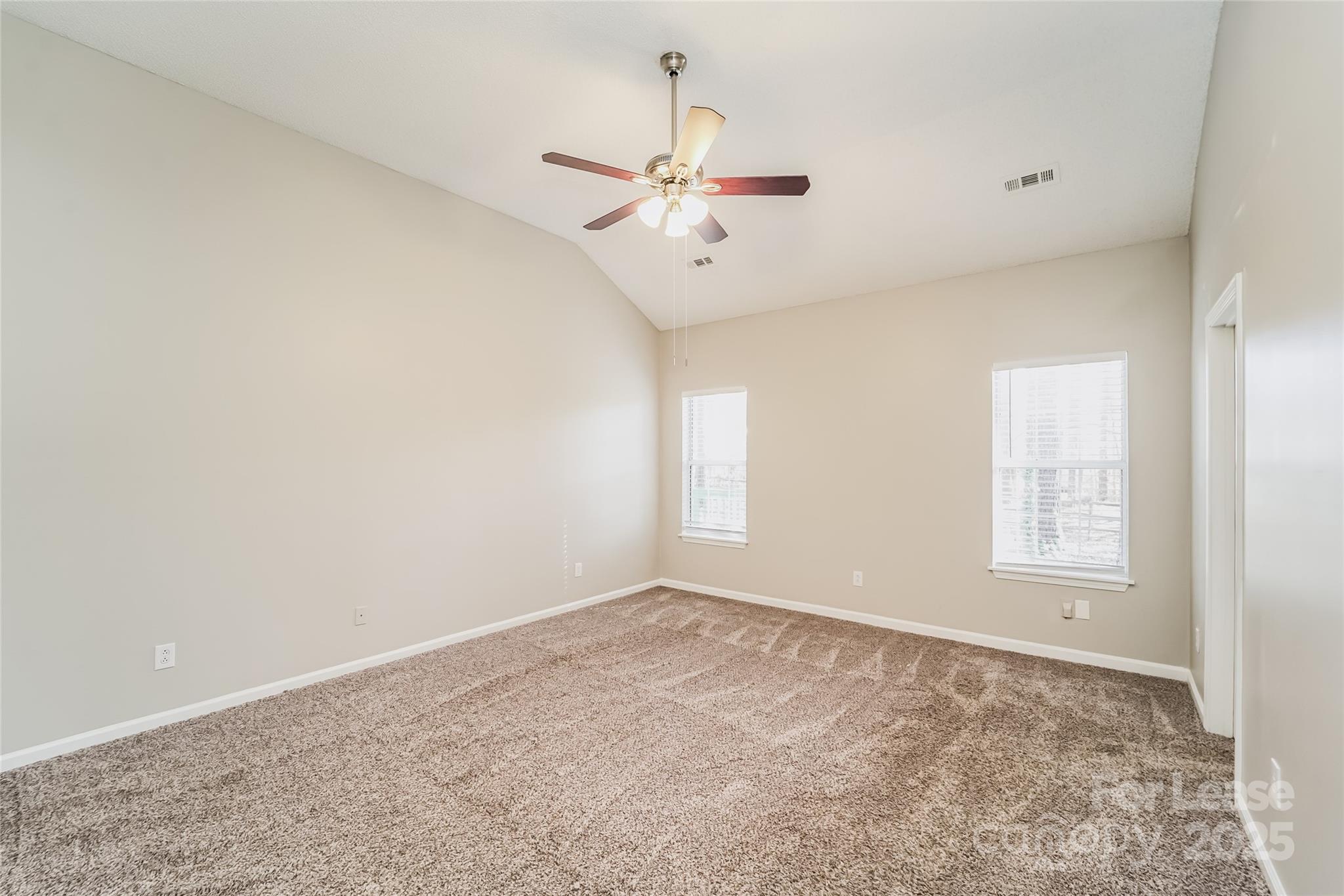 7121 Scuppernong Court Charlotte, NC 28215 - Photo 11 of 15 an empty room with windows and fan