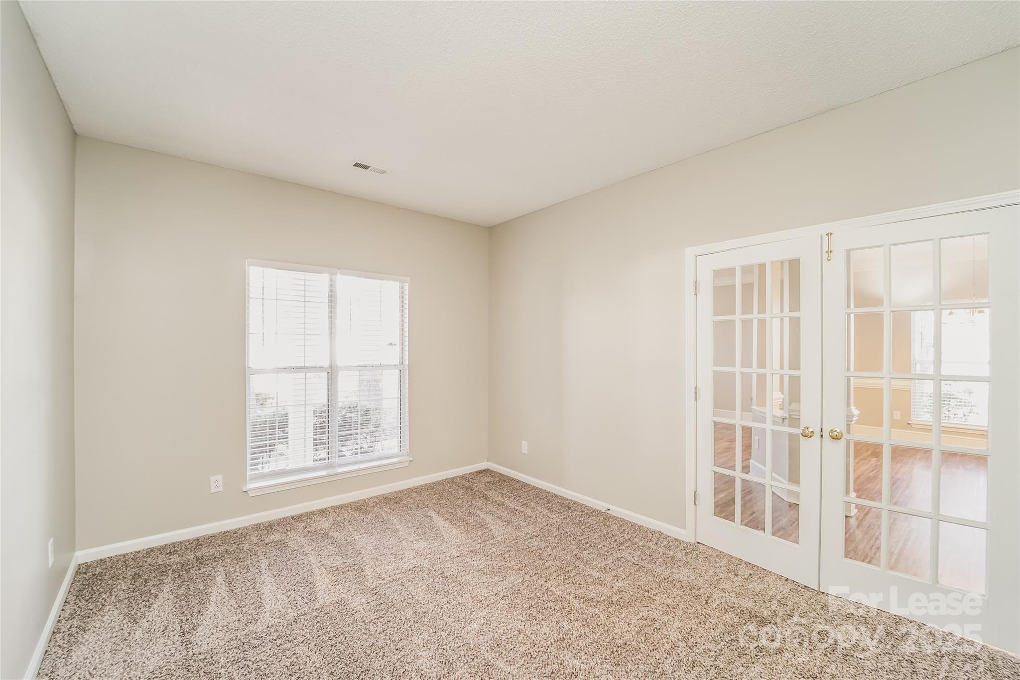 7121 Scuppernong Court Charlotte, NC 28215 - Photo 14 of 15 an empty room with windows
