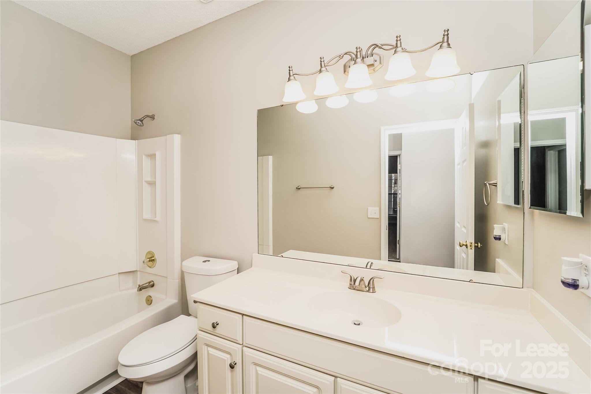 7121 Scuppernong Court Charlotte, NC 28215 - Photo 10 of 15 a bathroom with a sink a toilet and shower