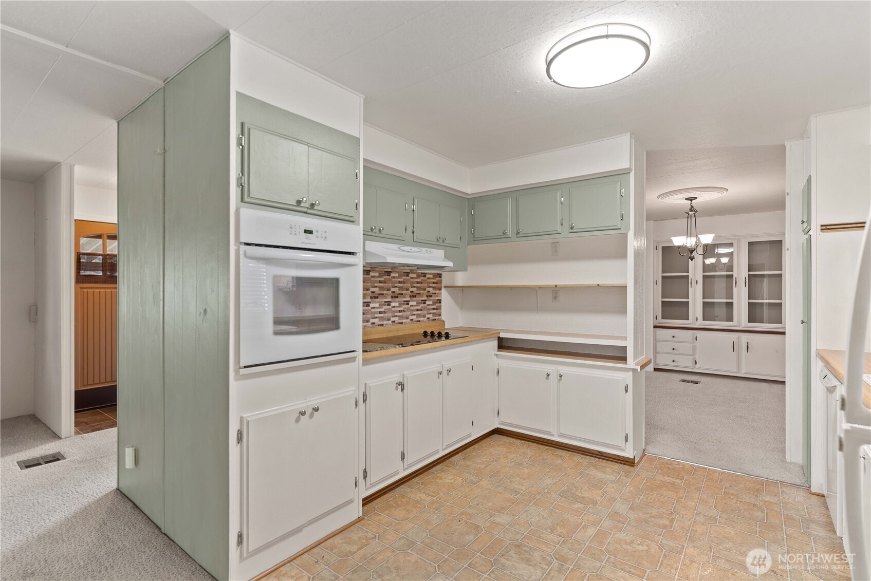 1311 Maple Street, Unit 18 Wenatchee, WA 98801 - Photo 11 of 28 a kitchen with white cabinets and white appliances