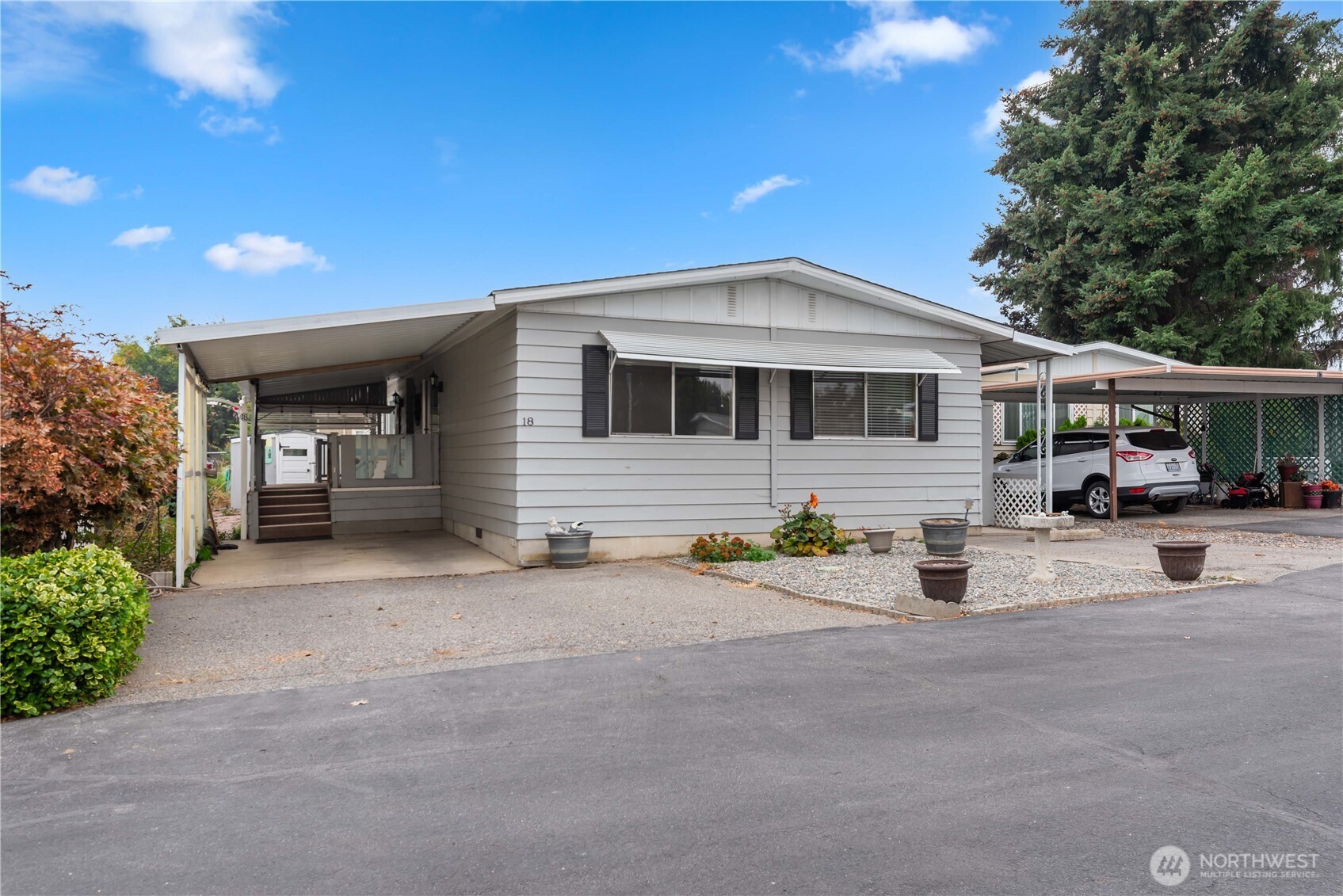 1311 Maple Street, Unit 18 Wenatchee, WA 98801 - Photo 3 of 28 a front view of a house with garage