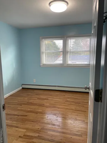 a view of a room with window and wooden floor