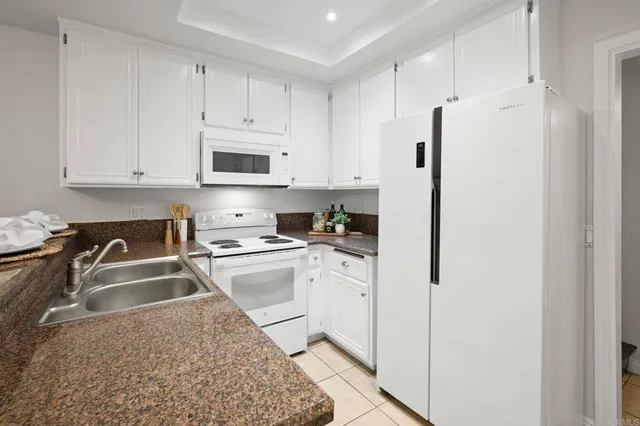 a patio with glass top table and chairs