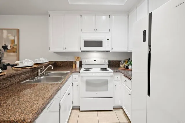 a view of a patio with a table and chairs and potted plants
