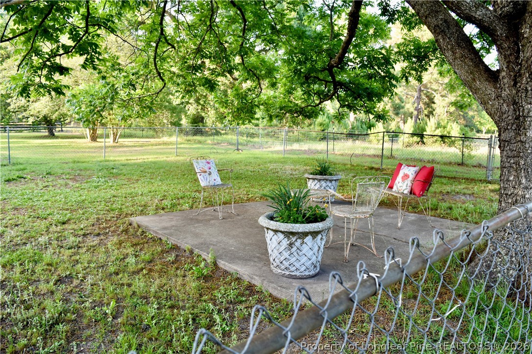 5309 Tobacco Road Orrum, NC 28369 - Photo 44 of 44 a view of a garden with sitting area and a lake view
