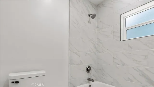 a bathroom with a toilet and shower