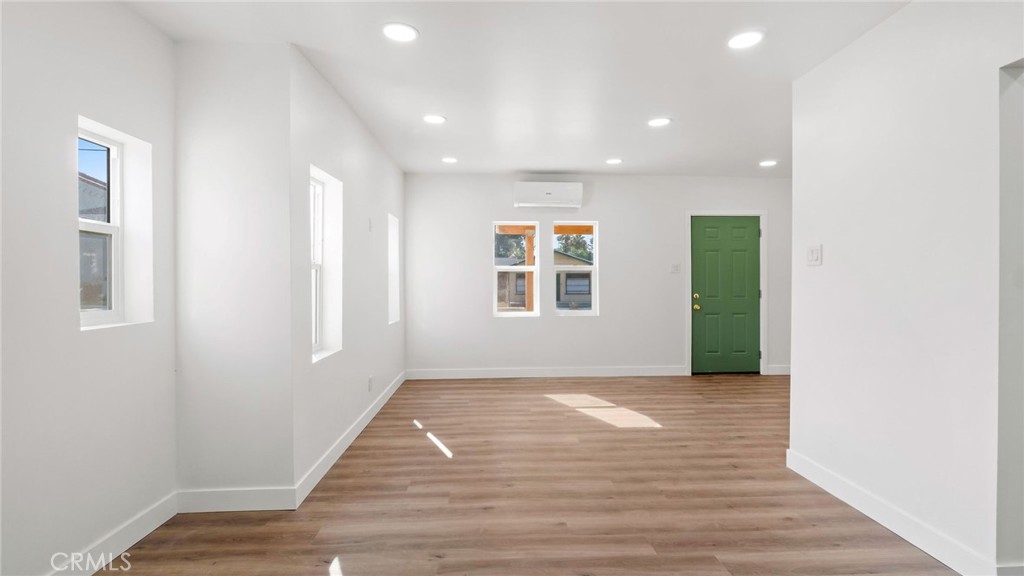 3309 Locust Street Riverside, CA 92501 - Photo 3 of 14 a view of an empty room with wooden floor and a window