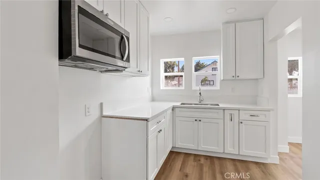 a kitchen with a sink cabinets and stainless steel appliances