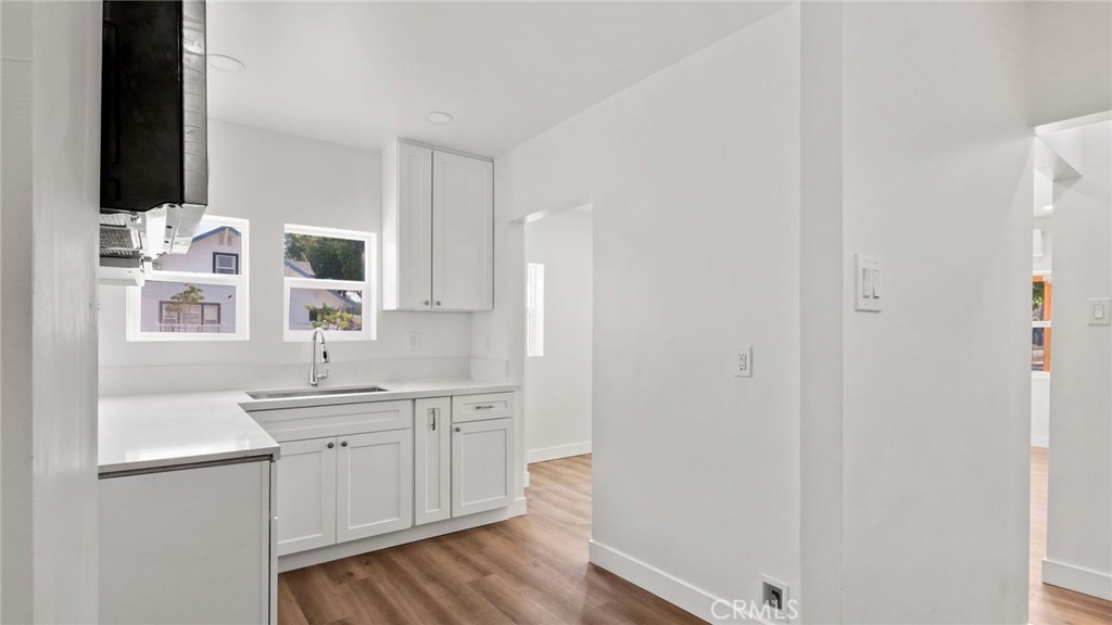 3309 Locust Street Riverside, CA 92501 - Photo 7 of 14 a kitchen with a sink cabinets and wooden floor