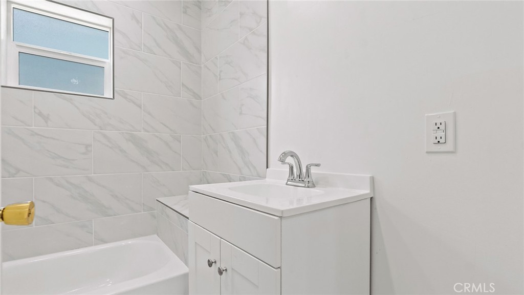 3309 Locust Street Riverside, CA 92501 - Photo 10 of 14 a bathroom with a sink and a mirror