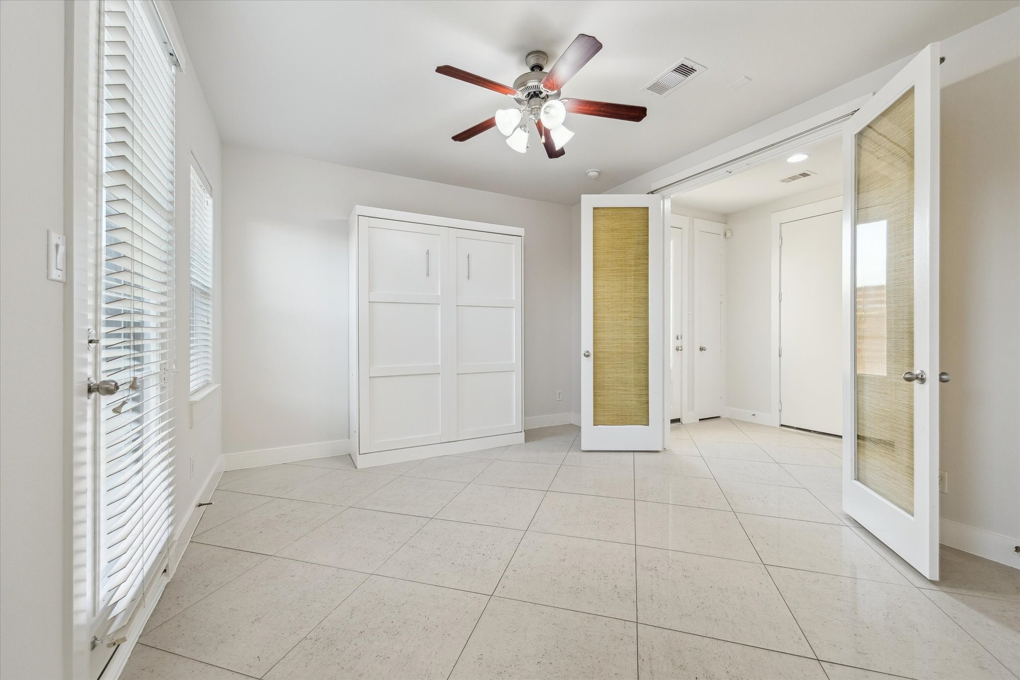 1819 Dart Street Houston, TX 77007 - Photo 11 of 30 The first floor bedroom features french doors and a removable Murphy Bed