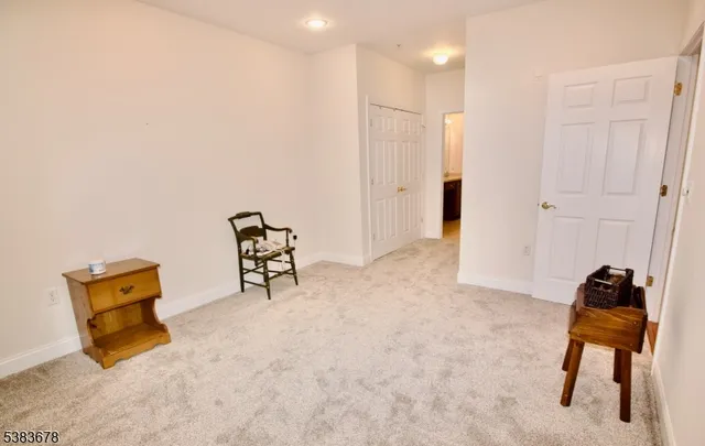 a hallway with a view of bedroom and wooden floor