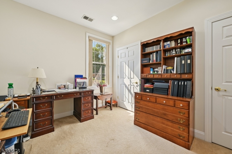 252 Victoria Drive, Unit 252 Bridgewater, NJ 08807 - Photo 15 of 26 a room with furniture a bookshelf and a window